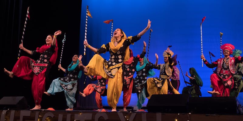 Indian dancers perform on stage in a Dances of the World Showcase.